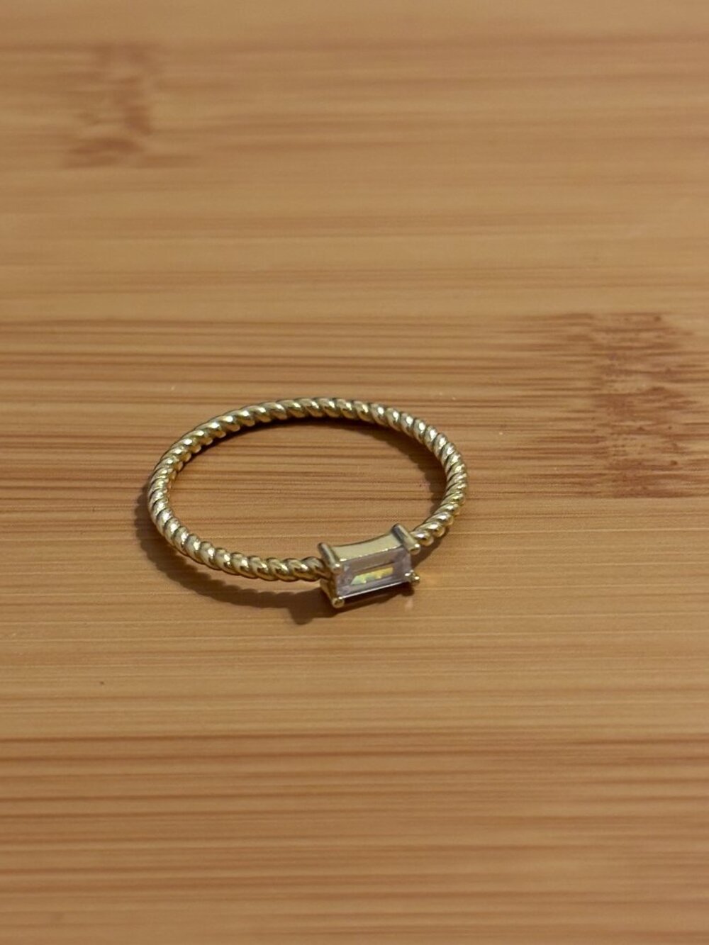 Gold Twisted Band Ring with Baguette Gem